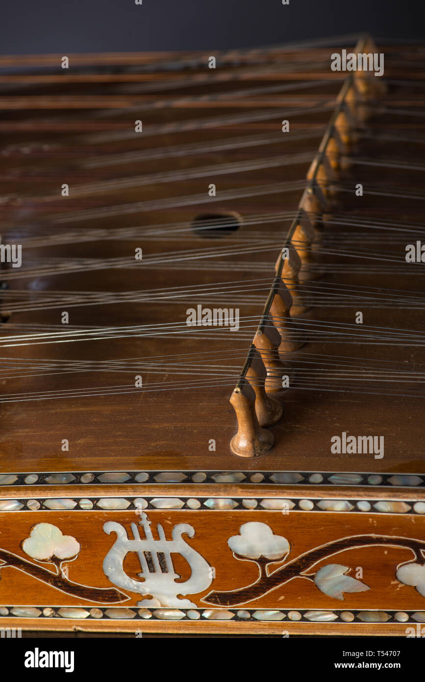 ancient Asian stringed musical instrument on black background with