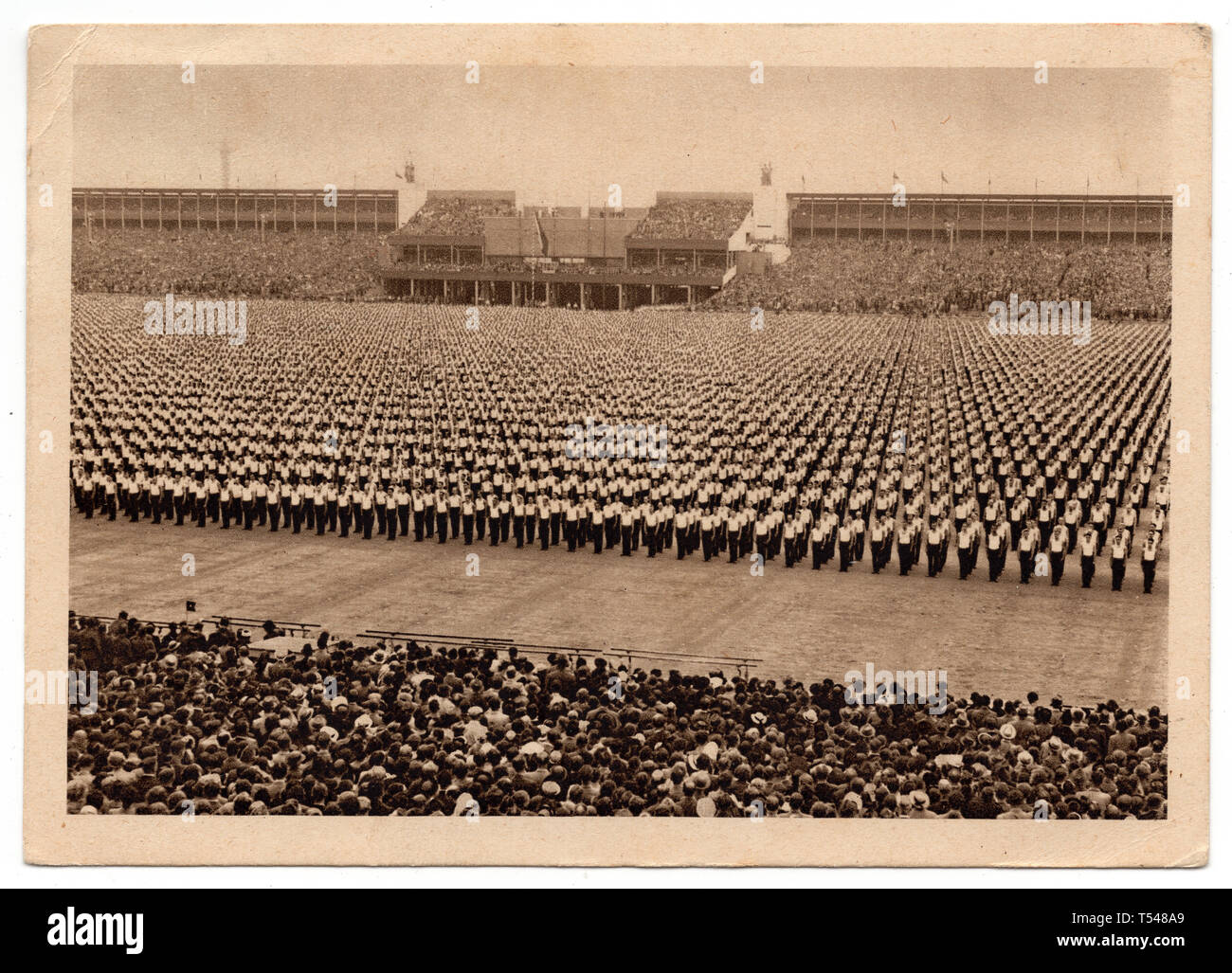 Sokol athletes perform on the Strahov Stadium (Strahovský stadion) on the first day of the 10th Sokol international mass gymnastics festival (X. všesokolský slet) in Prague, Czechoslovakia, on 3 July 1938. Black and white photograph by an unknown photographer published on the Czechoslovak vintage postcard issued in 1938. Courtesy of the Azoor Postcard Collection. Stock Photo