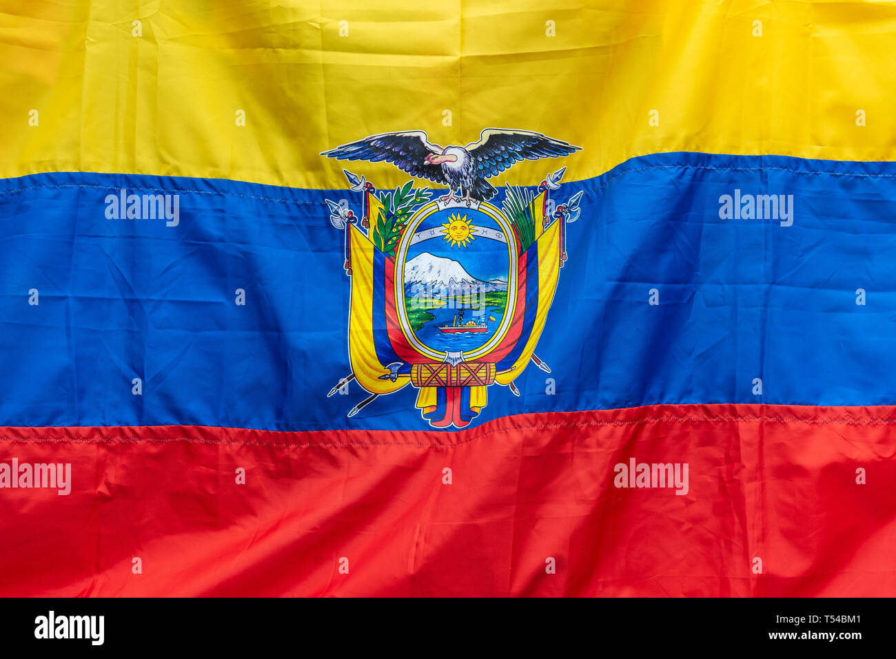 The flag of Ecuador, sign and concept of Ecuadorian patriotism. The flag shows the Andes condor, the Chimborazo volcano and the Guayas river. Stock Photo