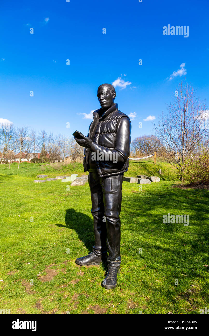 Sculpture of man holding a mobile phone by Thomas J Price, 'Network', 2013, in Three Mills part of The Line Sculpture Trail art walk, London, UK Stock Photo