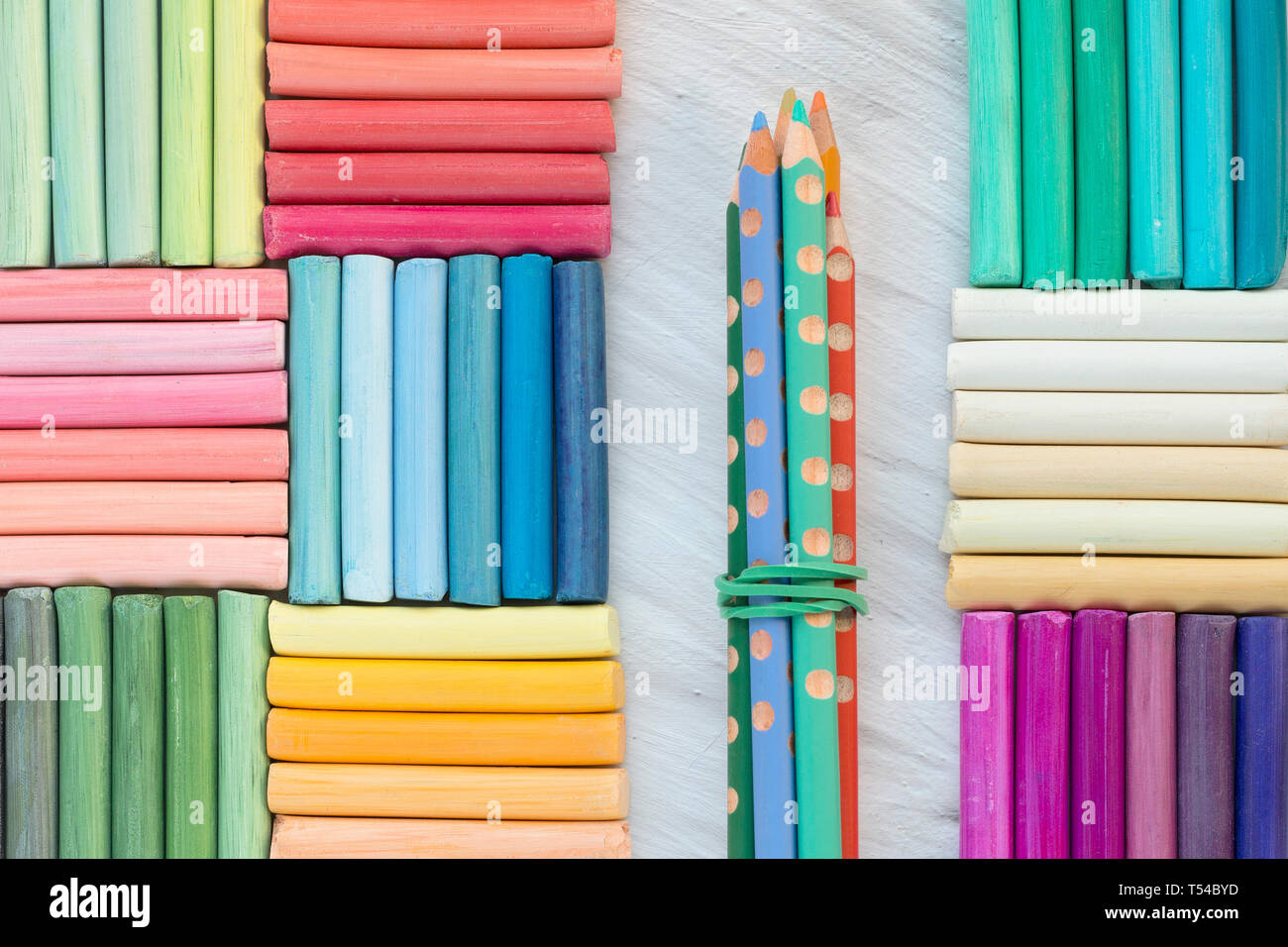 Bright background of rainbow pastel crayons and pencils. Vivid pattern. Back to school concept Stock Photo