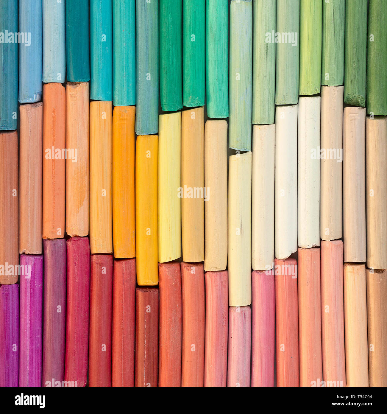 Multicolored rainbow pastel crayons in rows as background. Square image Stock Photo