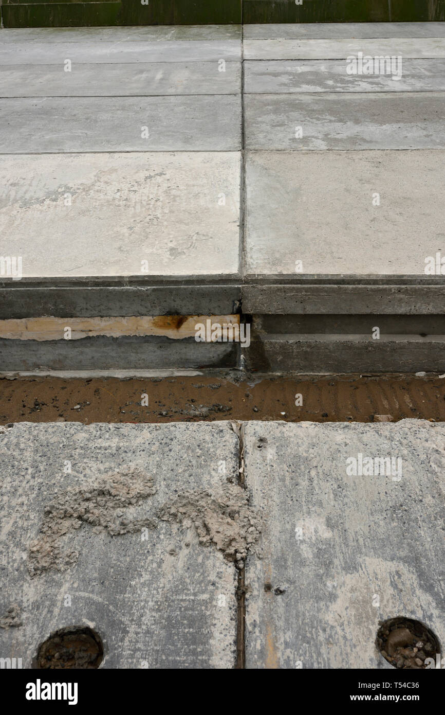Damaged concrete sloping revetment and expansion joints on sea defences