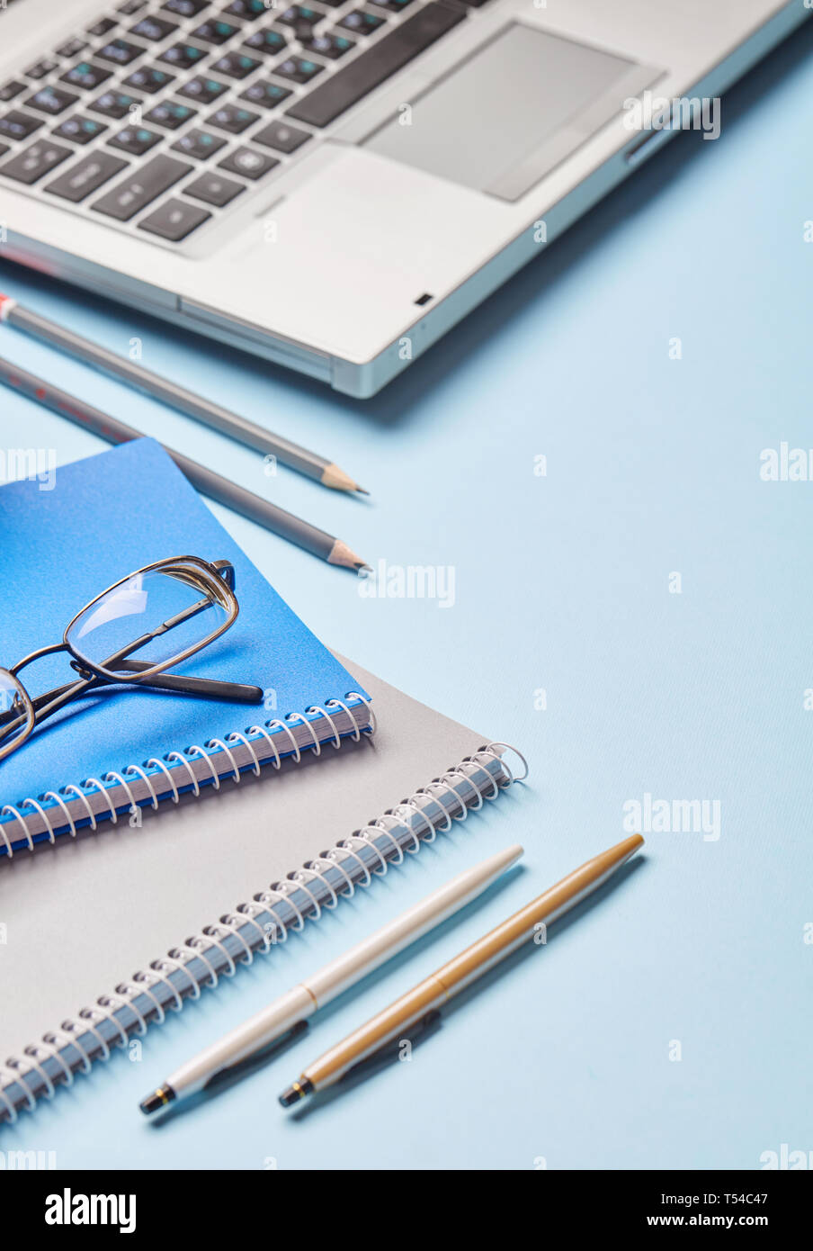 Workplace of the secretary - notebook, pen, sharpener and loptop. Group of school supplies on table Stock Photo
