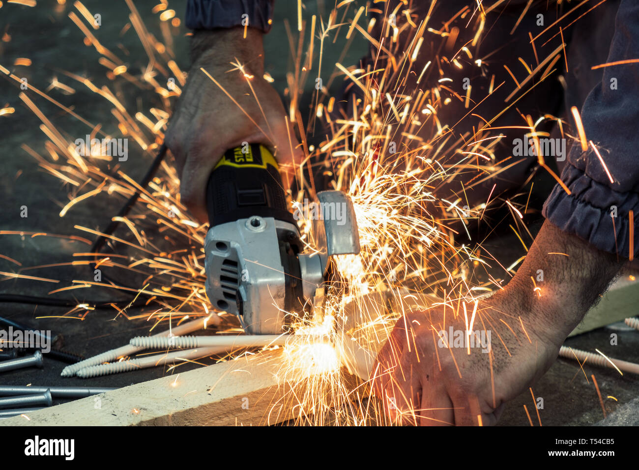 Worker cutting steel bars with a grinder Stock Photo Alamy