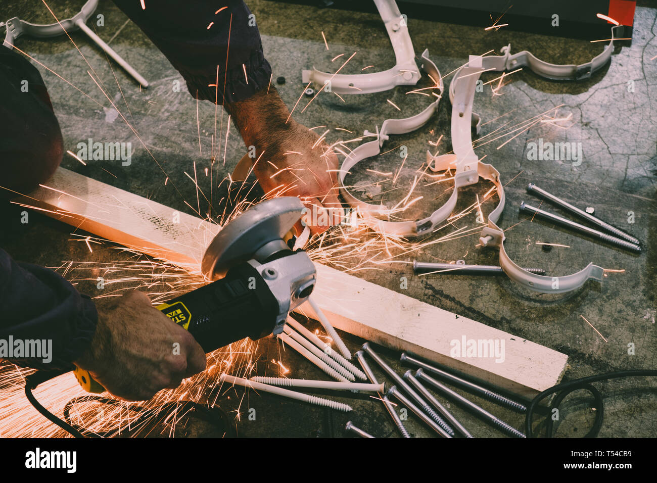 Worker cutting steel bars with a grinder Stock Photo Alamy