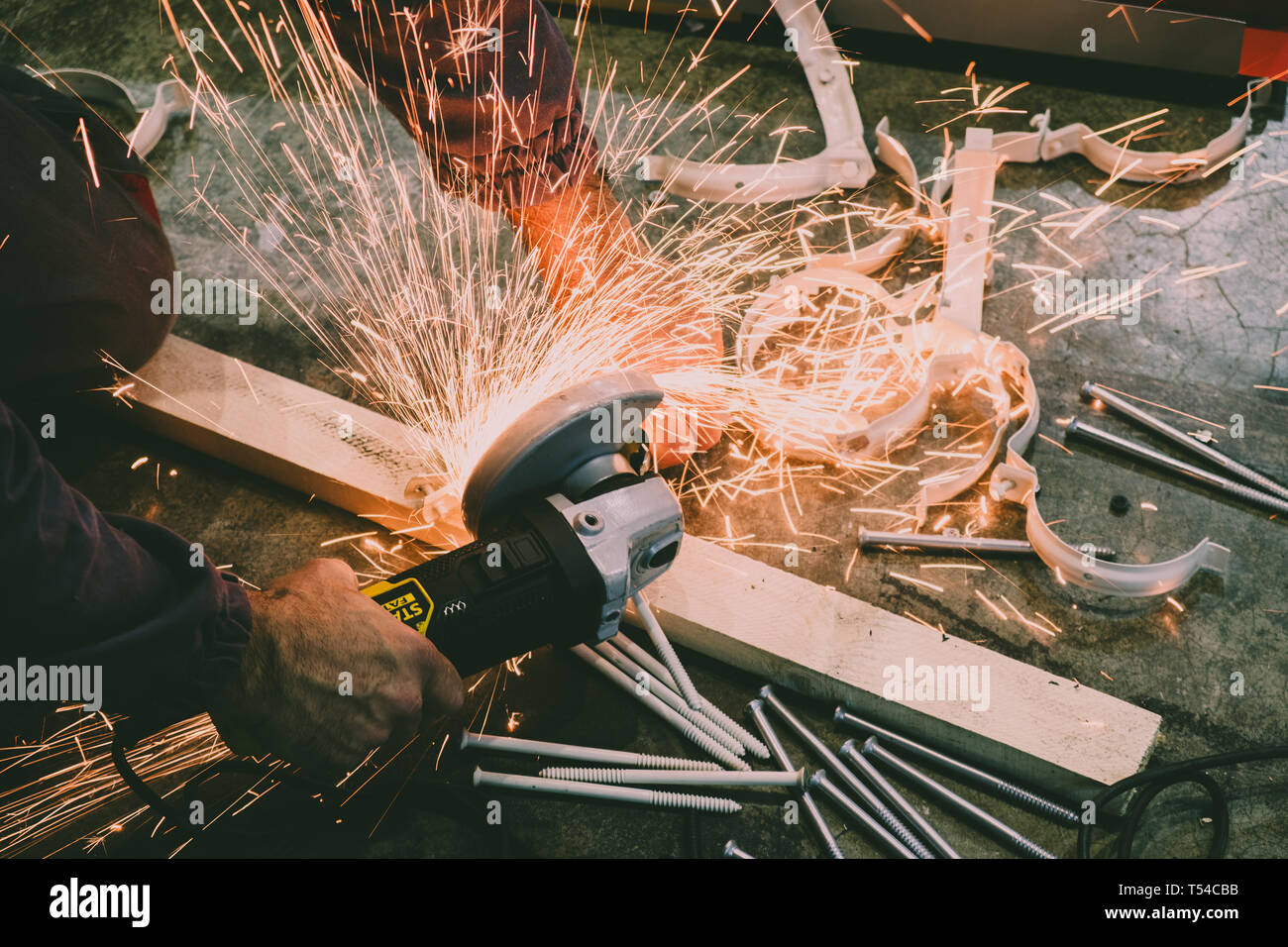 Worker cutting steel bars with a grinder Stock Photo Alamy