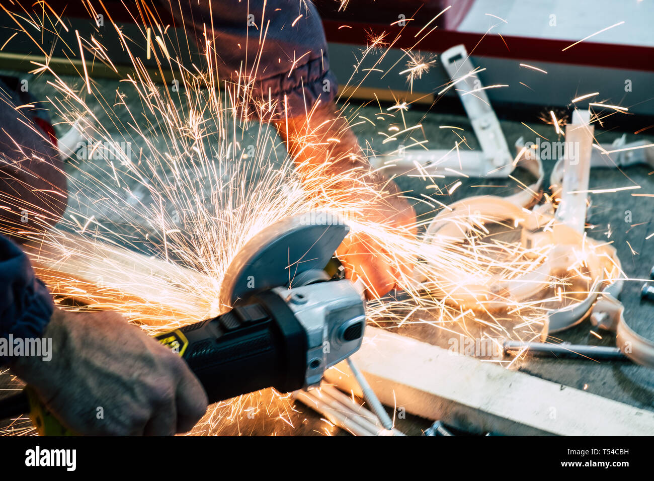 Worker cutting steel bars with a grinder Stock Photo Alamy