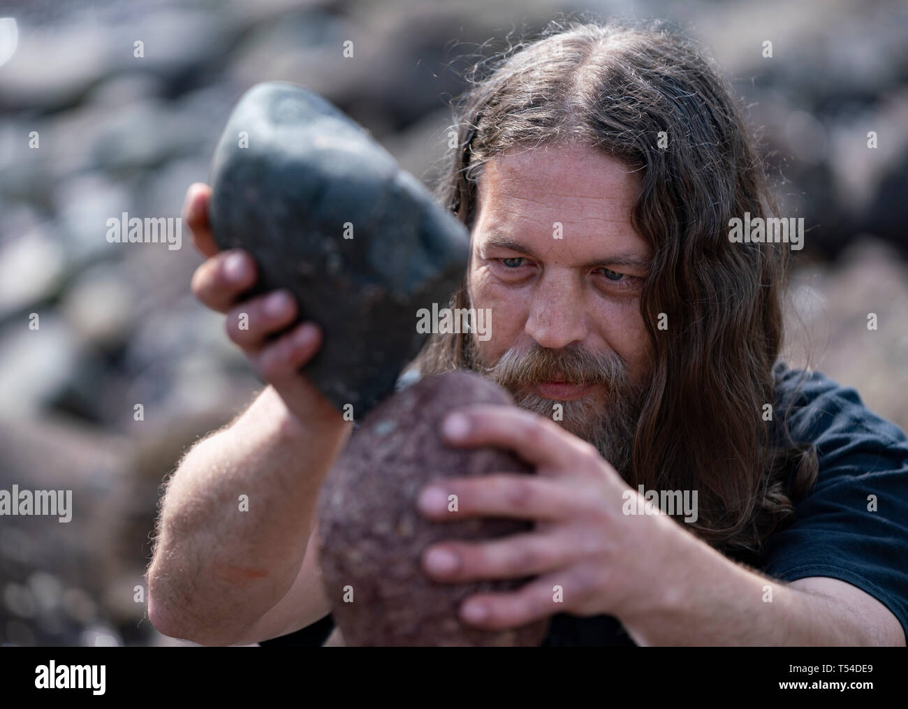 Dunbar, Scotland, UK. 20th Apr, 2019. Kev Potts working on his stone sculpture on Eye Cave beach in Dunbar during opening day of the European Stone Stacking Championship 2019. Credit: Iain Masterton/Alamy Live News Stock Photo