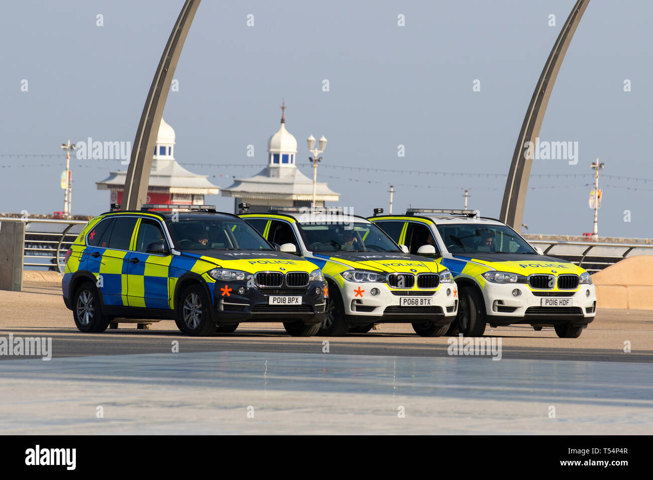 Blackpool, Lancashire. 21st April, 2019. UK Weather.  Bright sunny start to the day at the coast as people take to the seafront promenade for a light exercise and to enjoy the sea breeze on what is forecast to be the hottest day of the Easter holidays. Armed police are on patrol in Blackpool as part of the security operation surrounding Blackpool's Easter festival, Credit; MediaWorldImages/AlamyLiveNews. Stock Photo