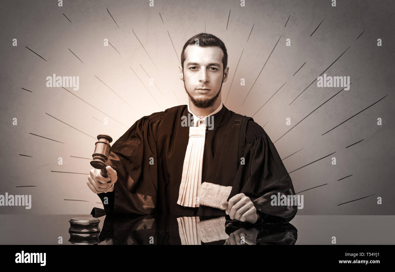 Young dashing judge in black gown making decision Stock Photo