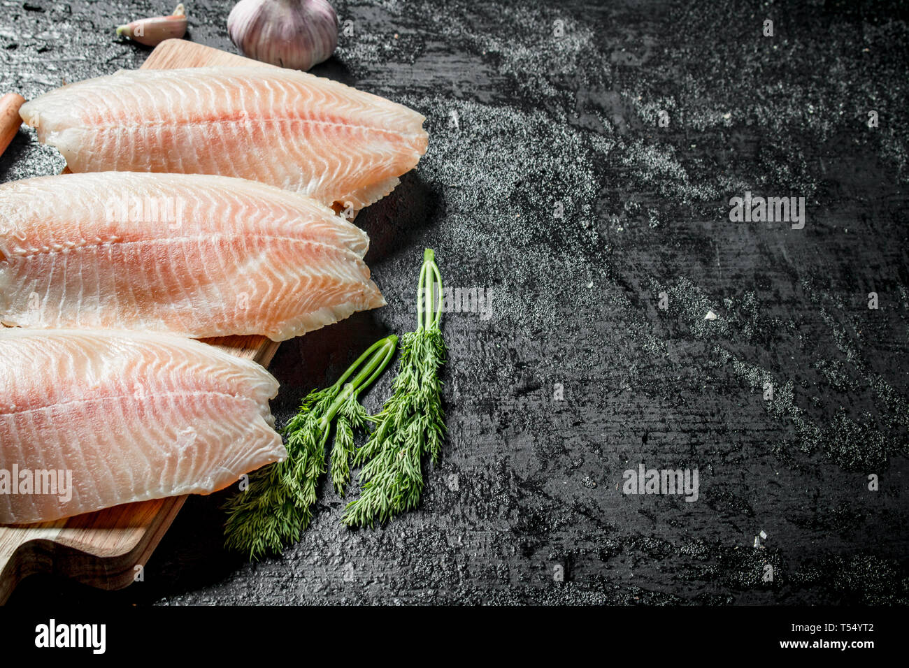 Tilapia Fish Fillet With Dill On Black Rustic Background Stock Photo Alamy