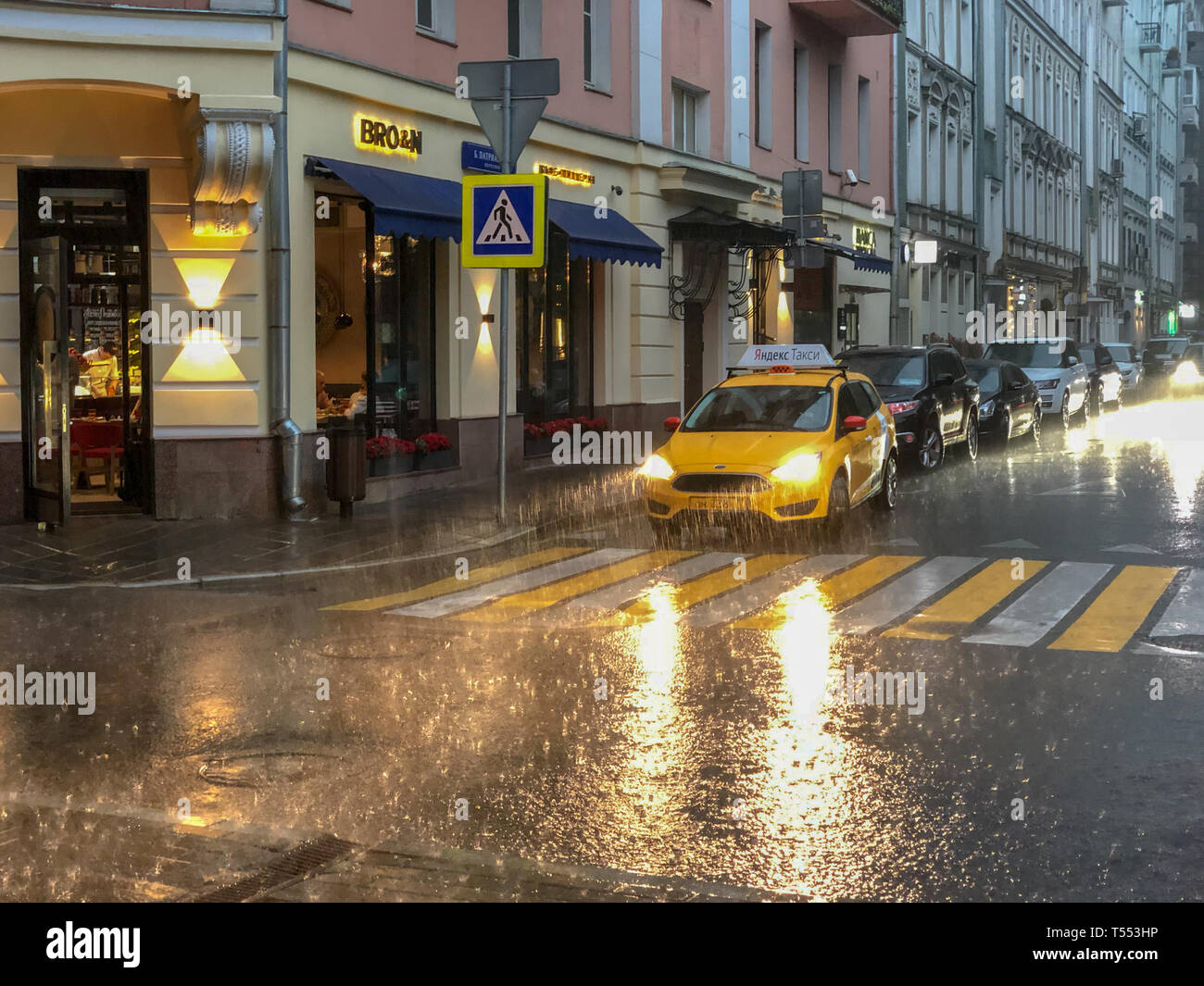 Moscow, Russia - July 19, 2018: Taxi on a rainy day in Patriarshiye Ponds, an affluent residential area in downtown Presnensky District of Moscow, Rus Stock Photo