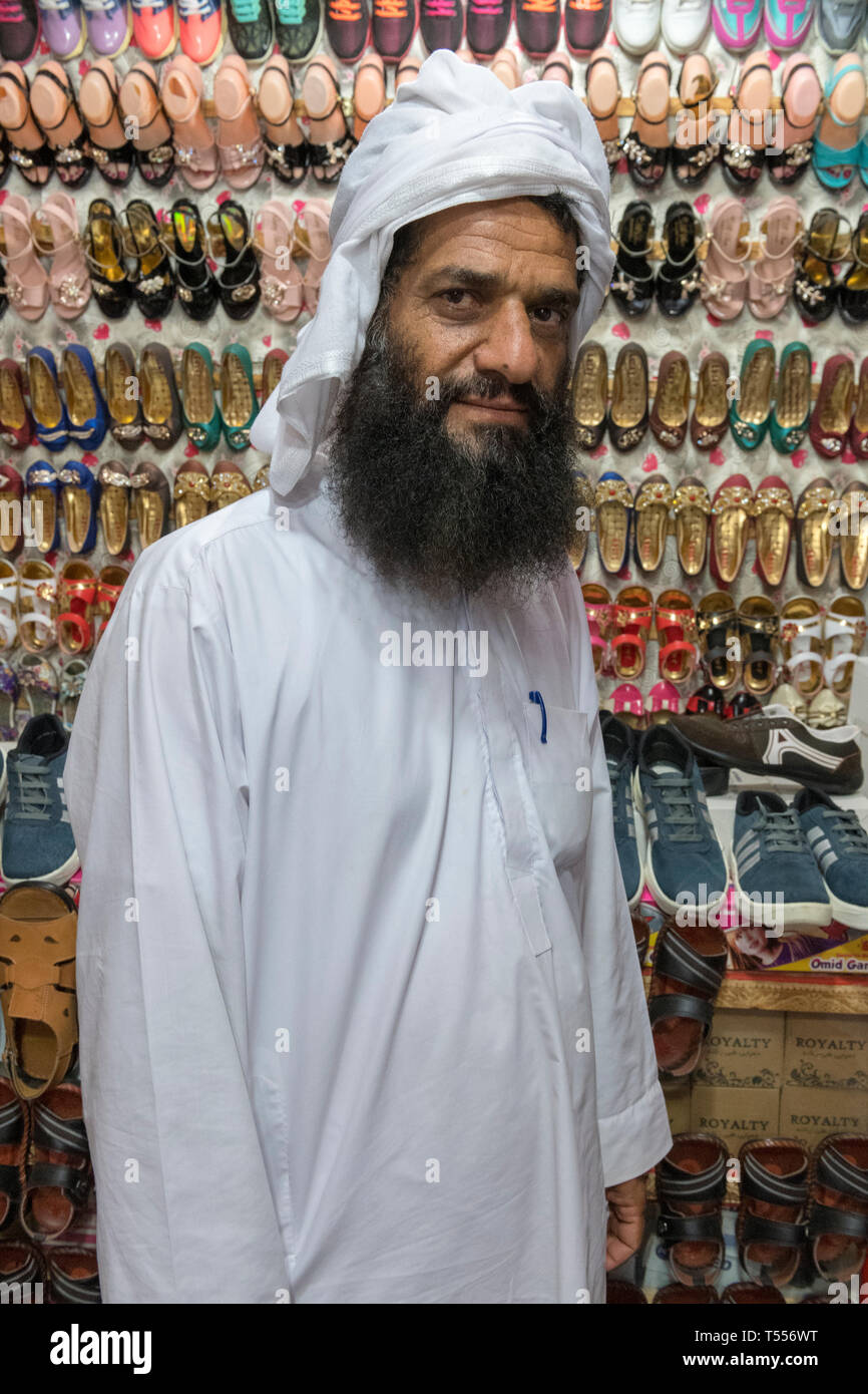 man selling shoes at the bazaar dust mohammad near zabol at the afghan border sistan and baluchistan iran T556WT