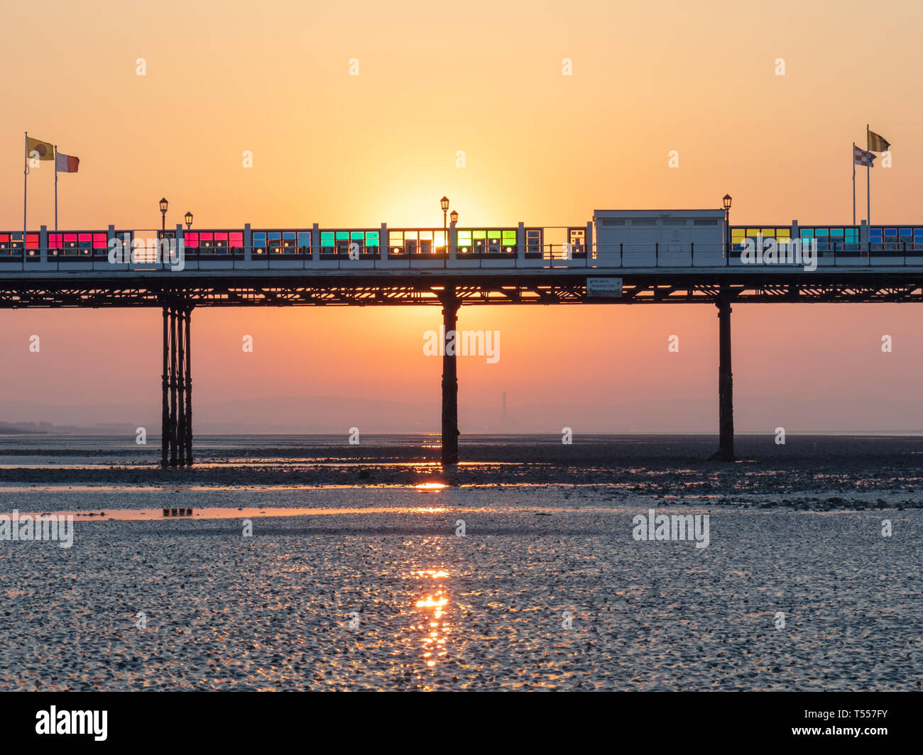 Worthing, Sussex, UK; 20th April 2019; Dawn With Sun Rising Behind Worthing Pier at Low Tide Stock Photo