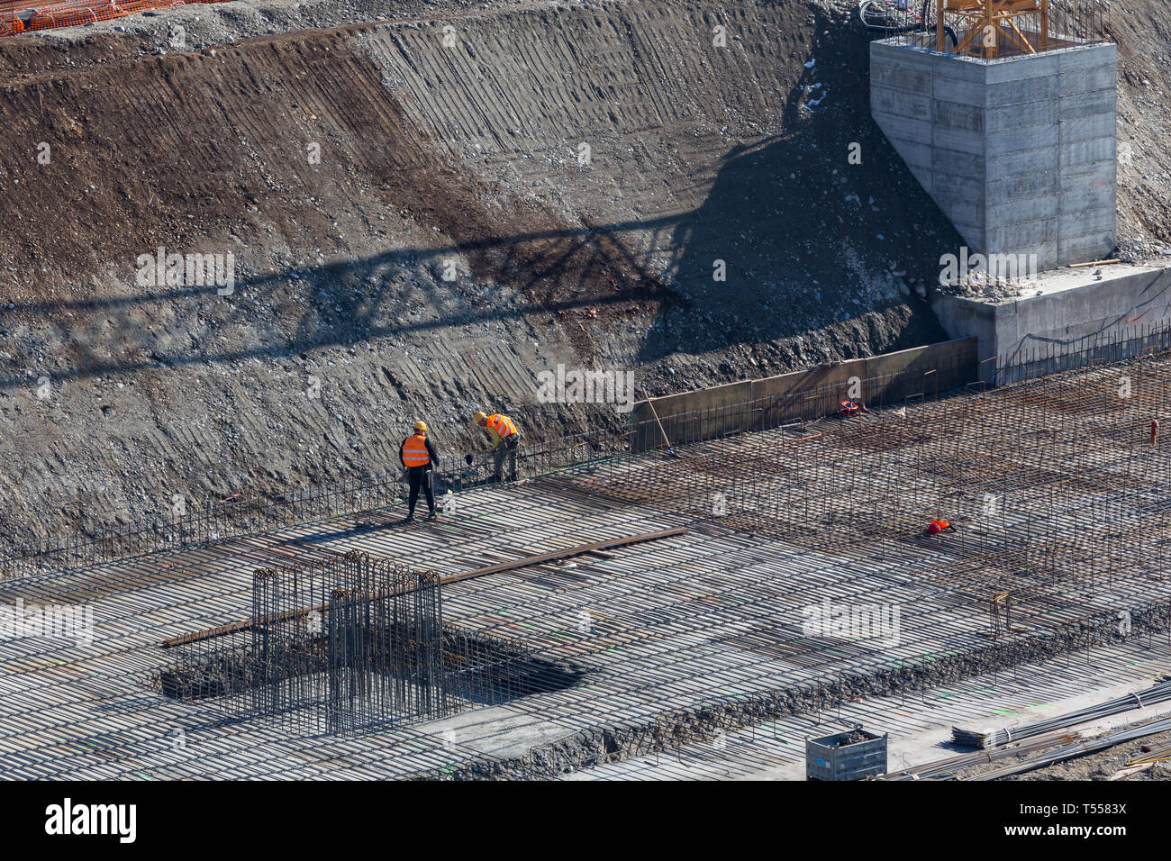 Construction of the building. Workers unrecognizable make metal ...