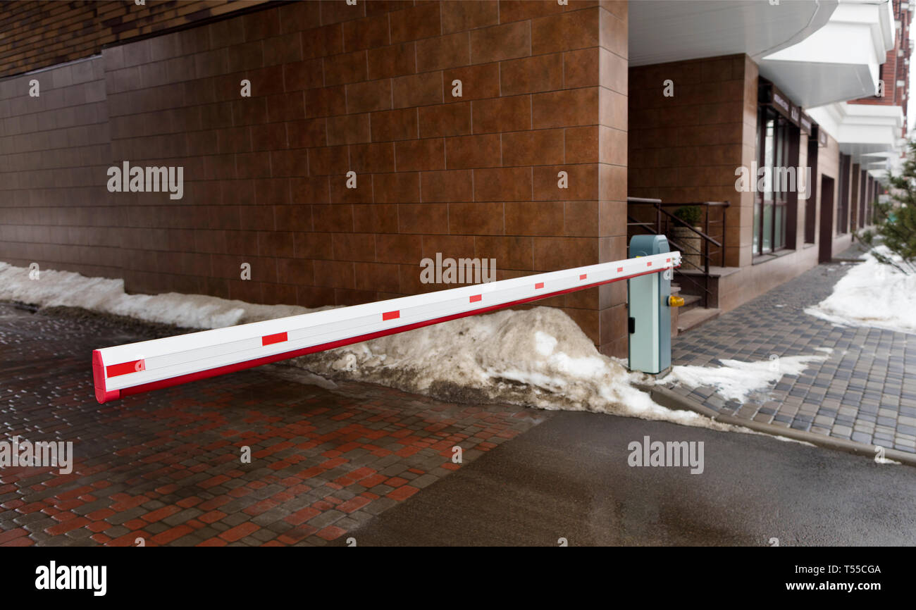 Automatic barrier gates to enter the courtyard of the building serve as