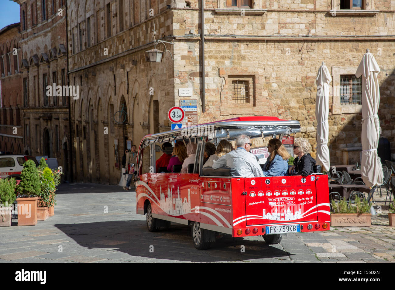 Montepulciano tour sightseeing small bus departs the town square piazza for a tour of this medieval hilltop town in Tuscany,Italy,Europe Stock Photo