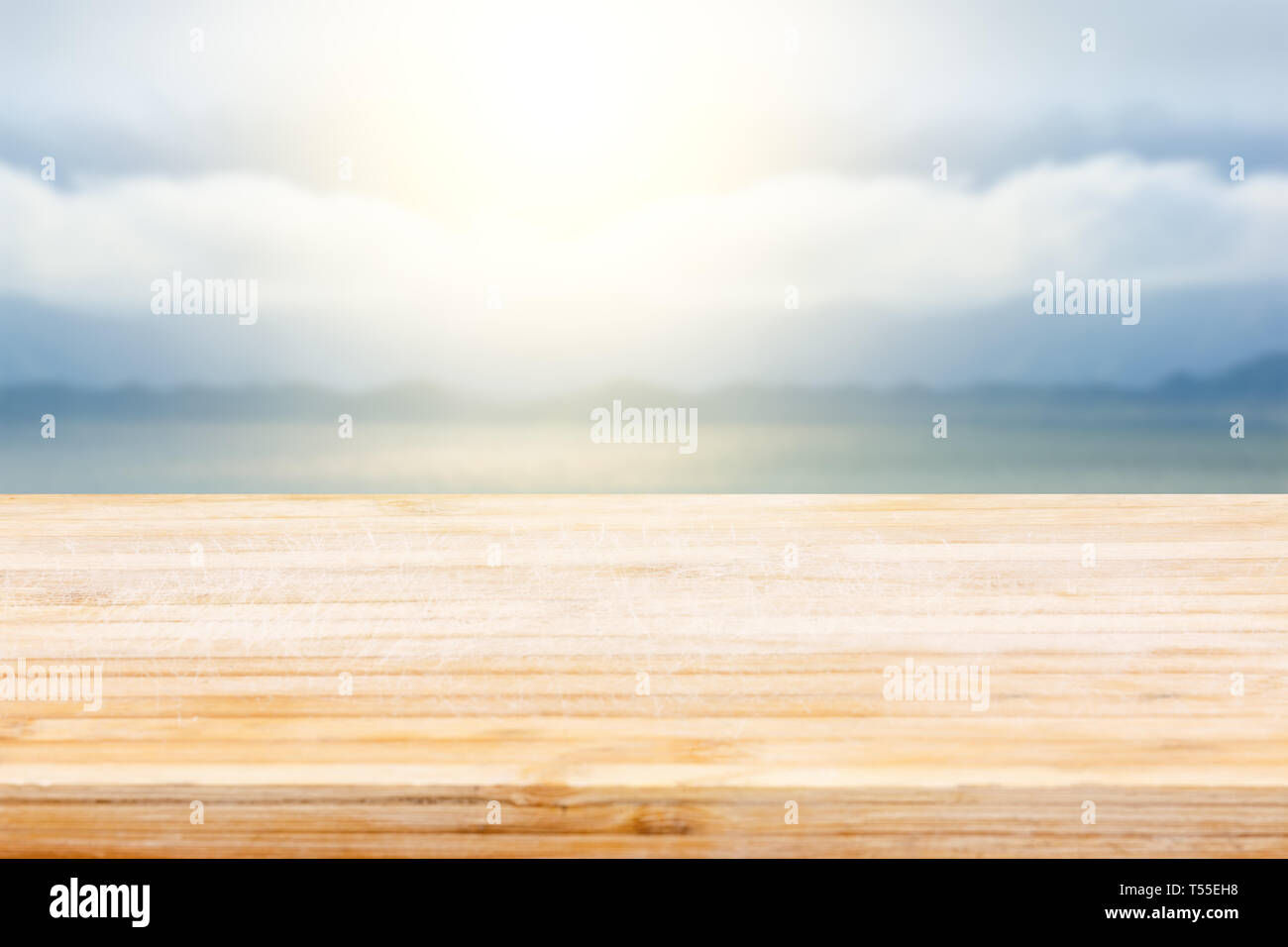 Wooden table and lake with sky background Stock Photo