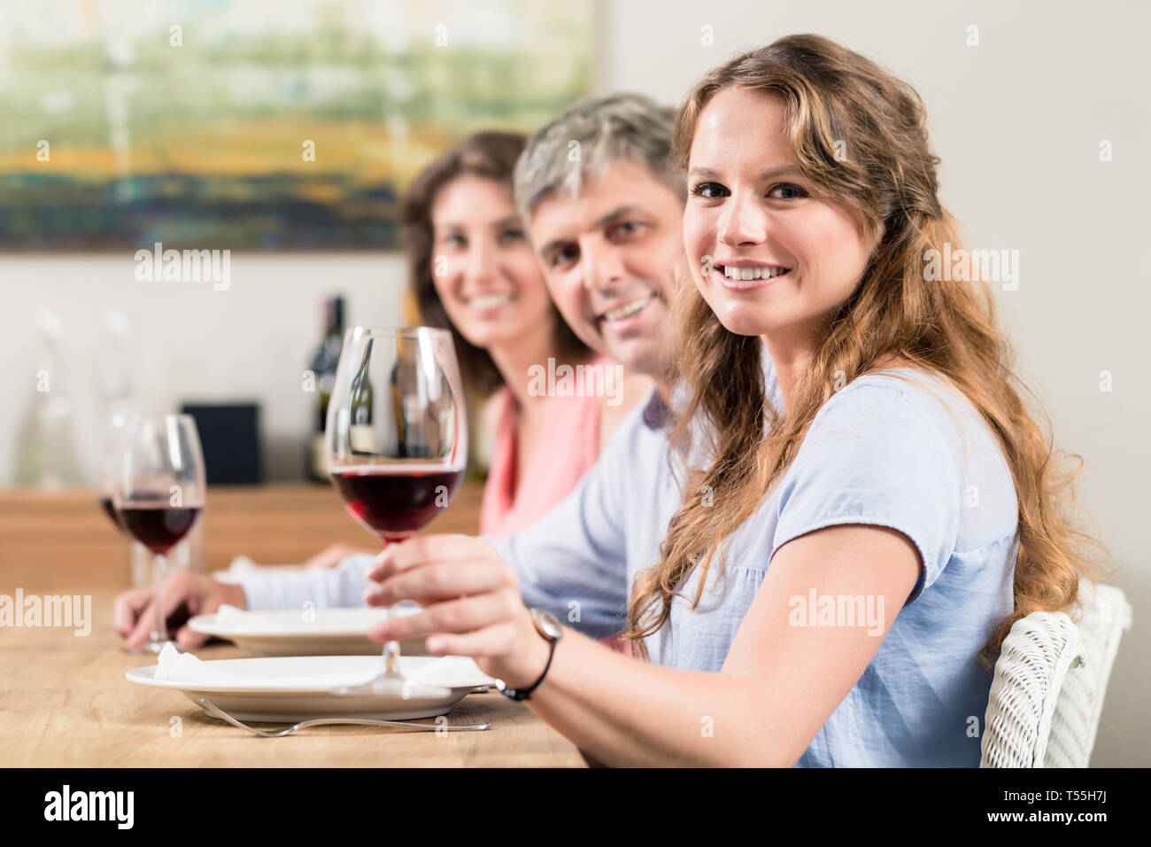 Woman raising wine glass hi-res stock photography and images - Alamy