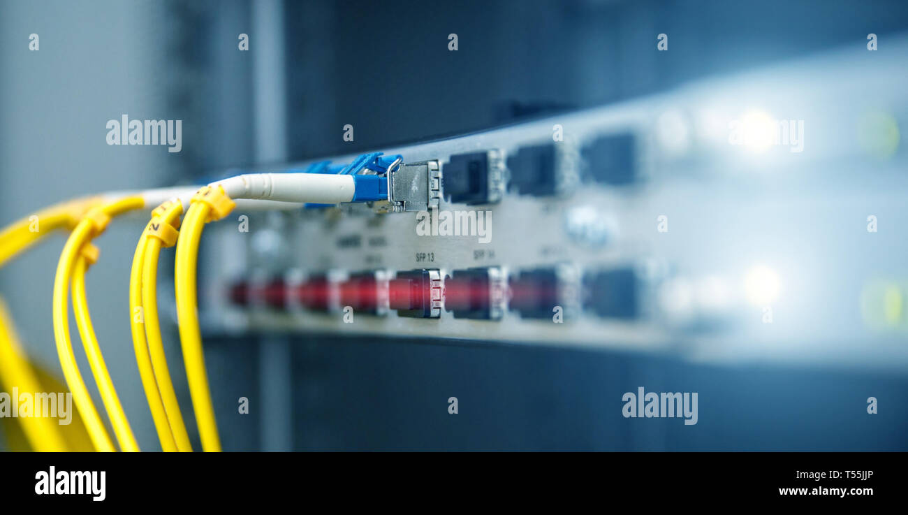 Technology banner. Close up fiber optic cable. Servers racks. Severs computer in a rack at the large data center. Photo contains noise Stock Photo