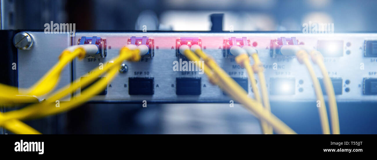Technology banner. Close up fiber optic cable. Servers racks. Severs computer in a rack at the large data center. Photo contains noise Stock Photo