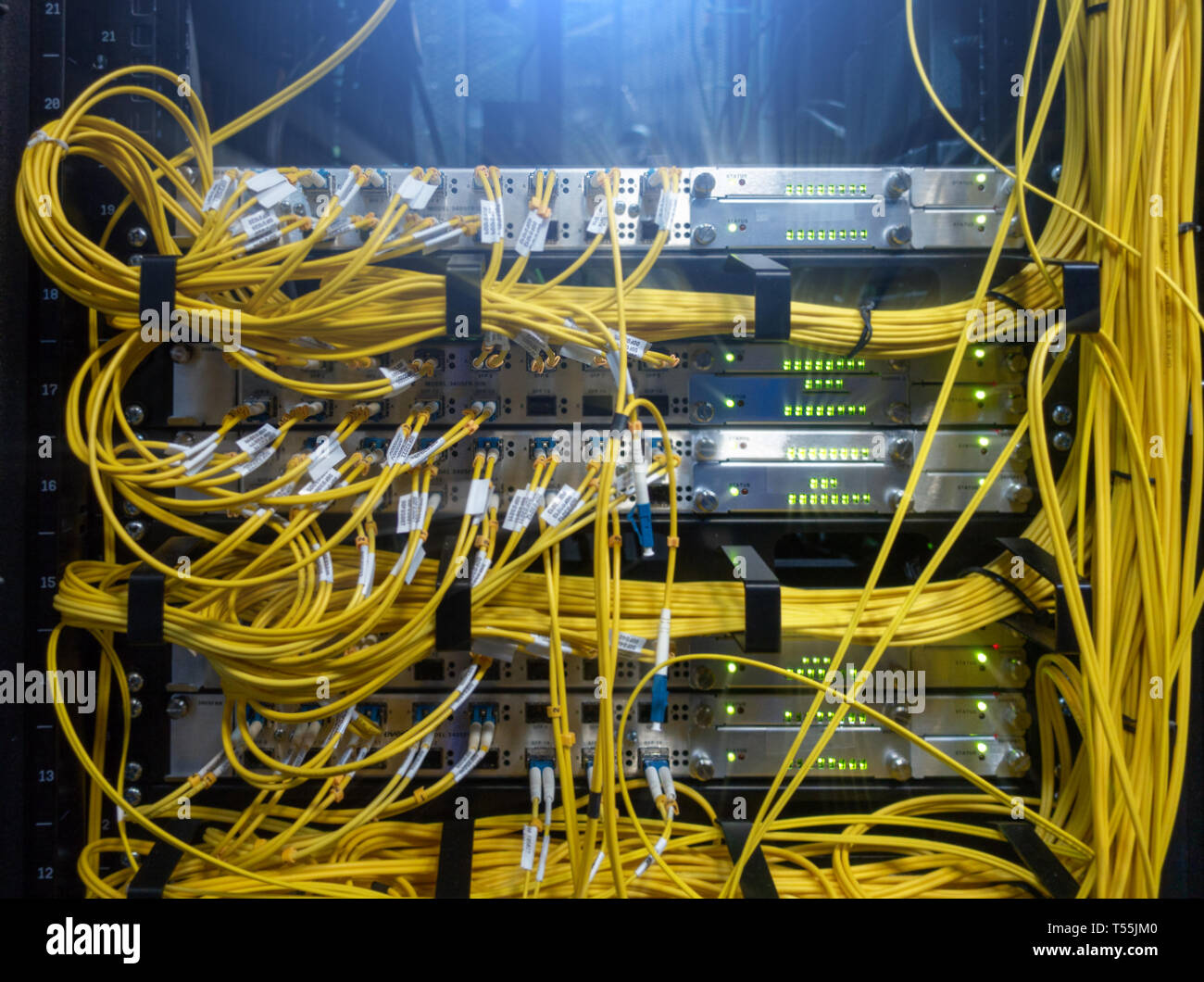 Rack with powerful Internet servers. The monitor is installed in a computer  cabinet. A central router with multiple optical cables is located in the d  Stock Photo - Alamy