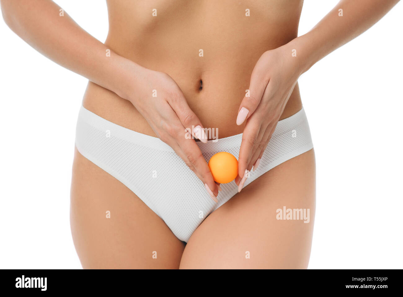woman showing ovulation process holding near ovary ball like ovum. Stock Photo