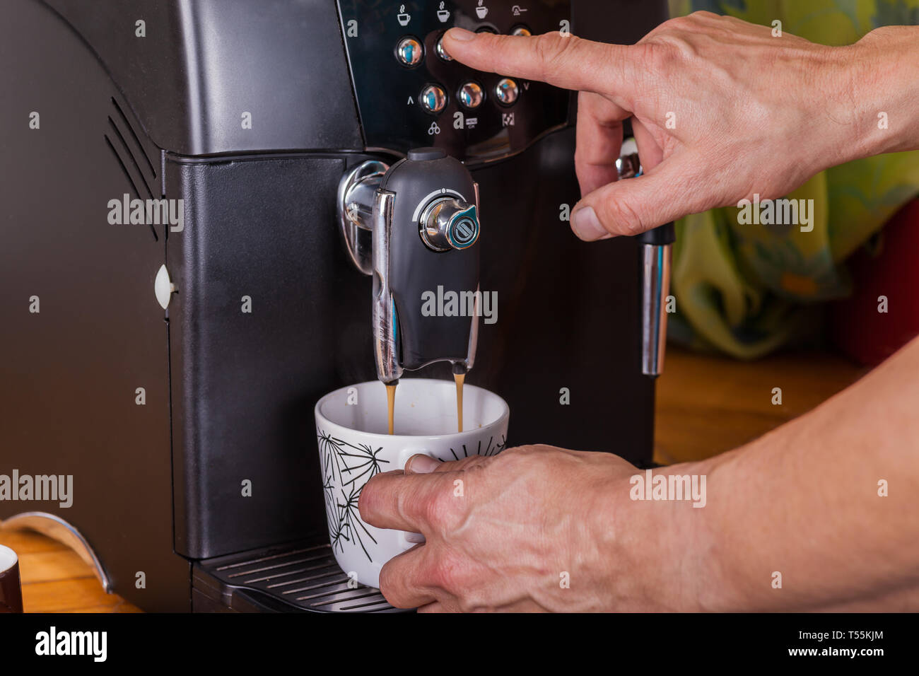 Two hands operate a coffee machine Stock Photo Alamy