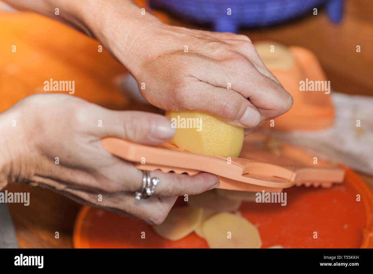 Woman hand working on a potato grater Stock Photo