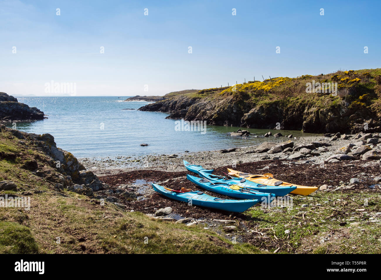 Sea kayaks beached in a small rocky cove on west coast. Rhoscolyn, Holy