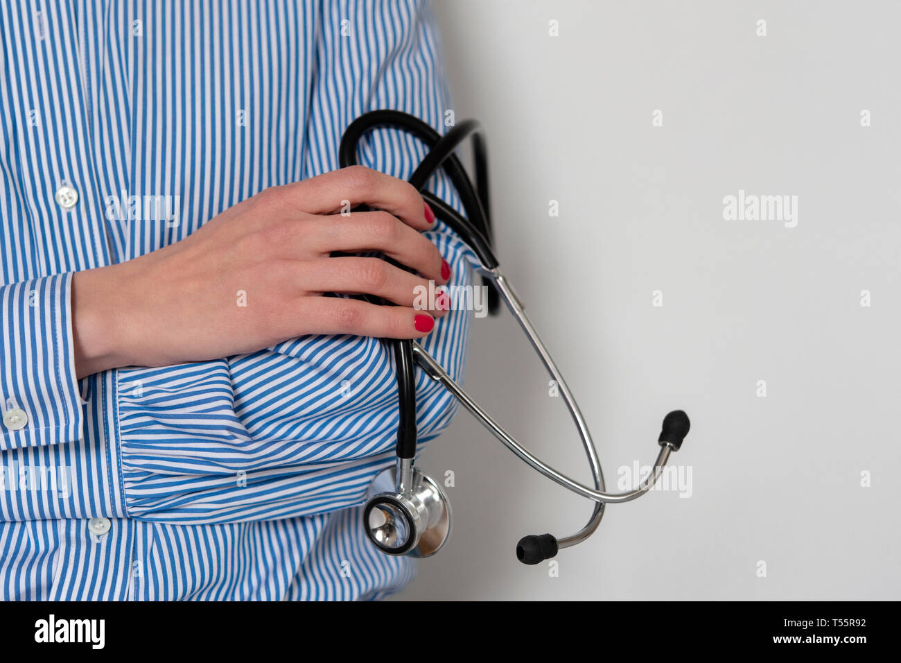 Doctor holding stethoscope Stock Photo