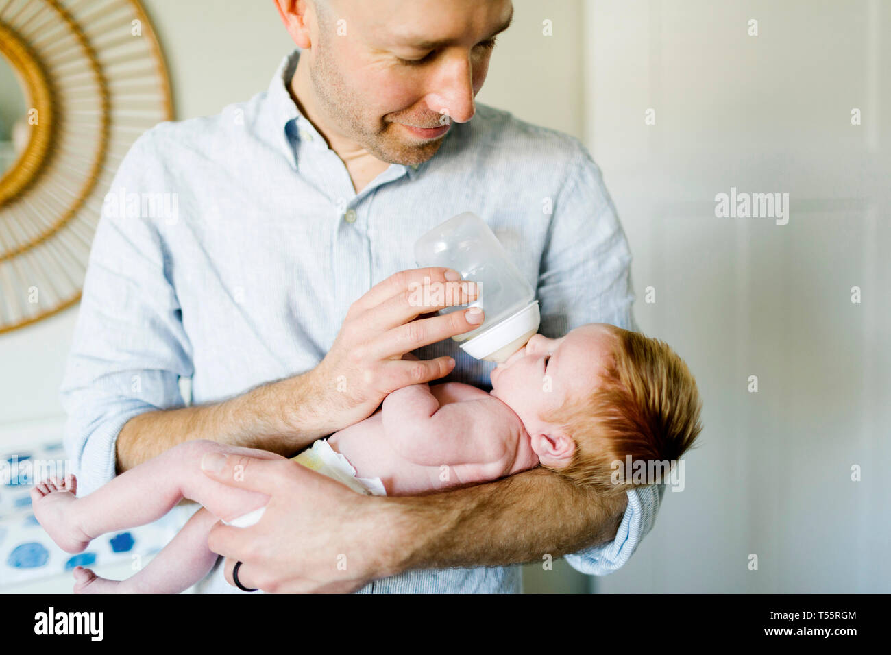 Man feeding his baby son Stock Photo