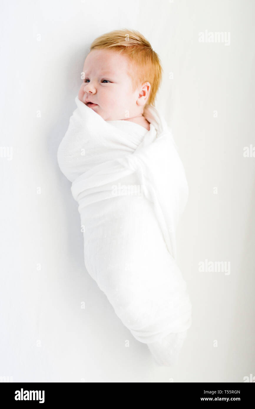 Baby swaddled in a blanket hires stock photography and images Alamy
