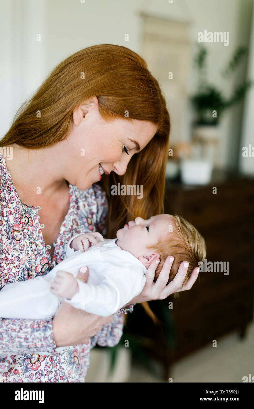 Woman holding her newborn son Stock Photo
