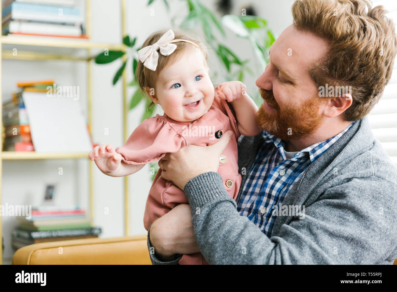 Smiling father holding his baby girl Stock Photo