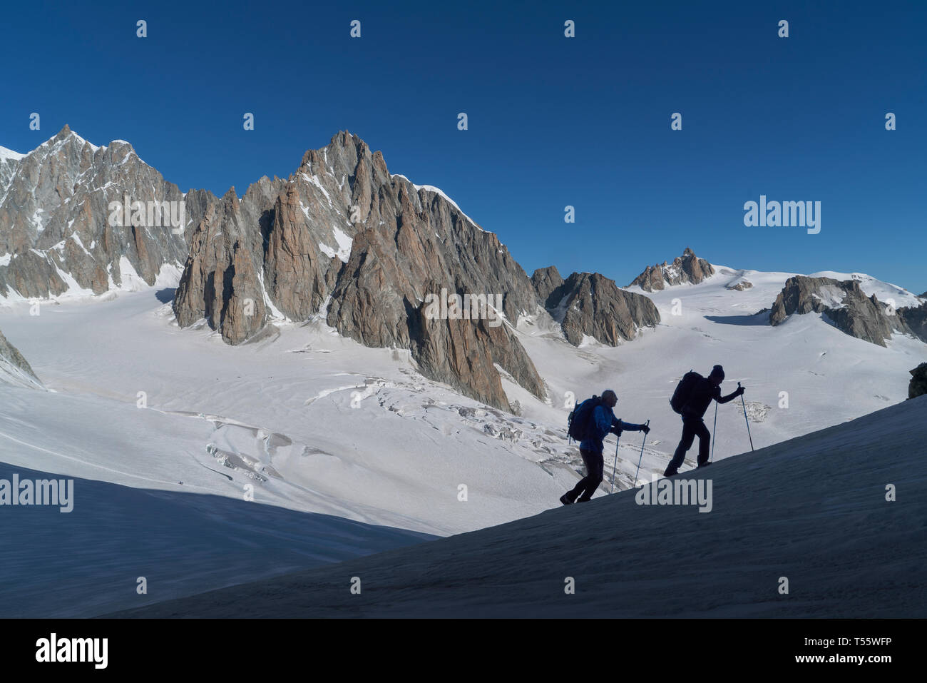 Silhouettes of hikers on Mer de Glace in Mont Blanc massif, France Stock Photo