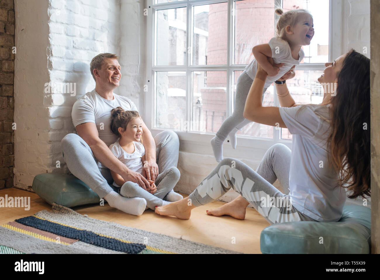 Family sitting by window Stock Photo