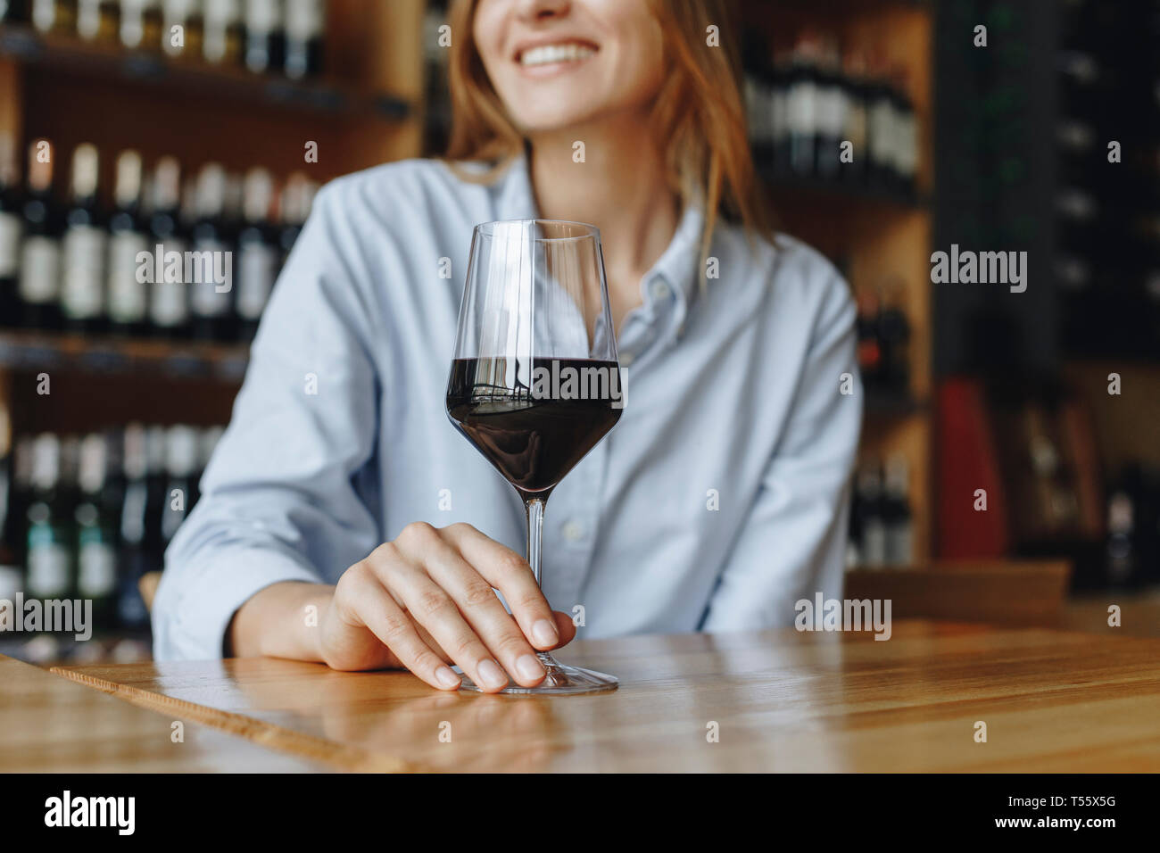 Woman holding glass of red wine Stock Photo - Alamy