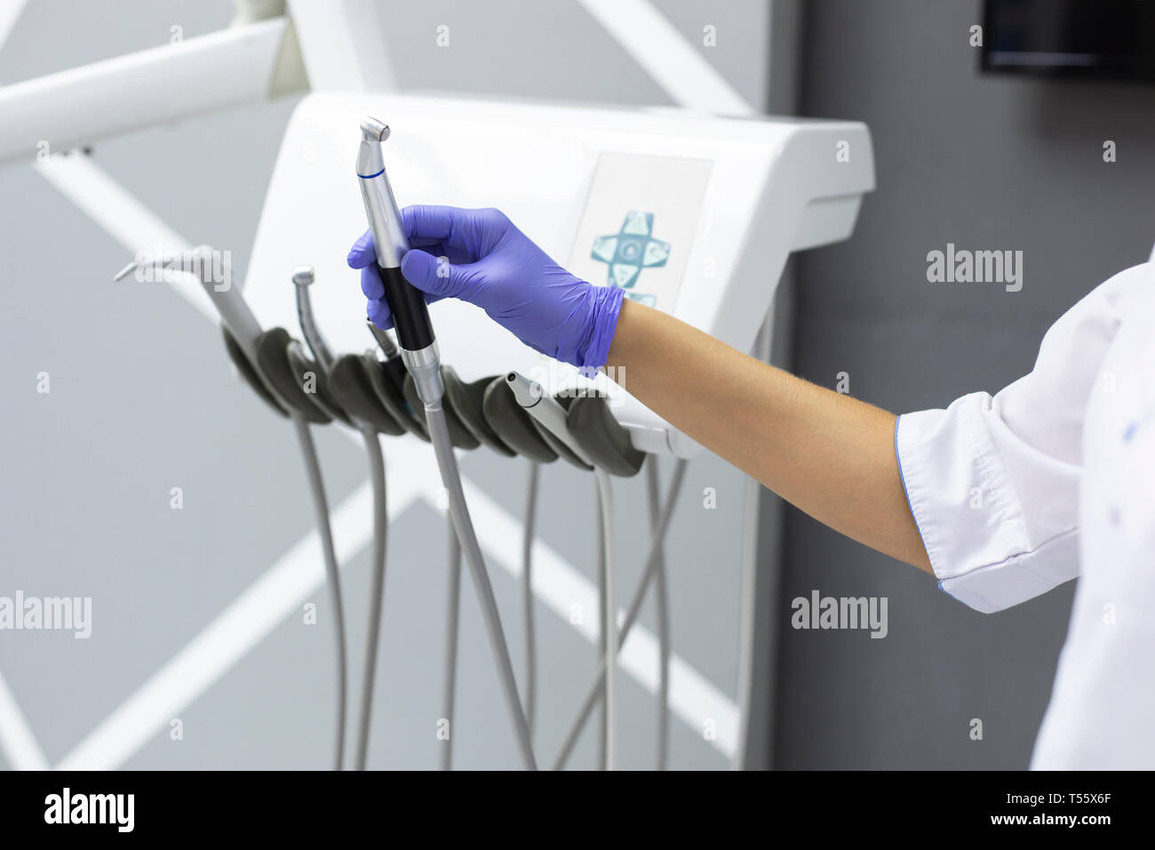 Dental assistant holding dental equipment Stock Photo Alamy