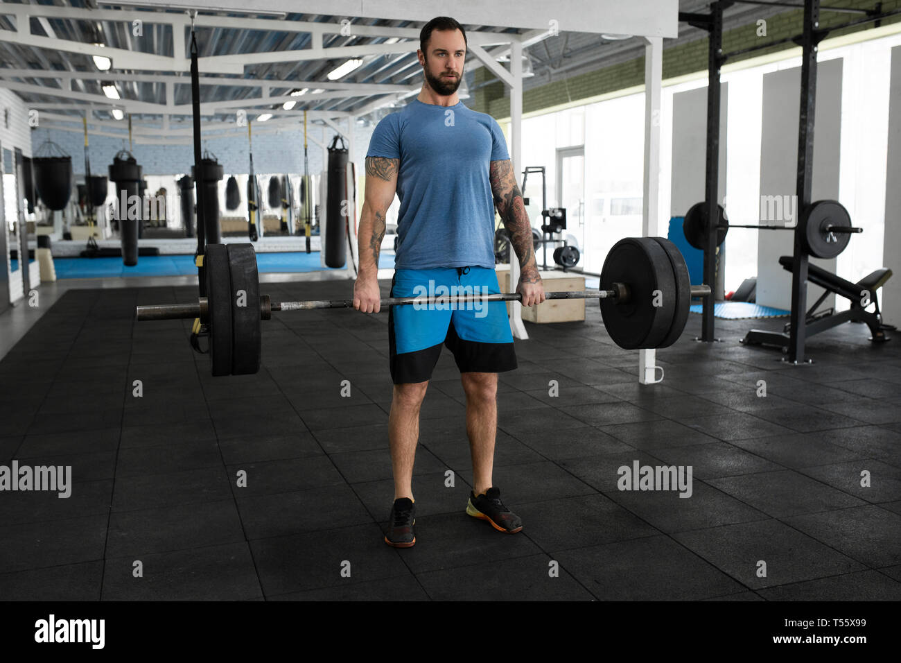 Mid adult man weight lifting in gym Stock Photo