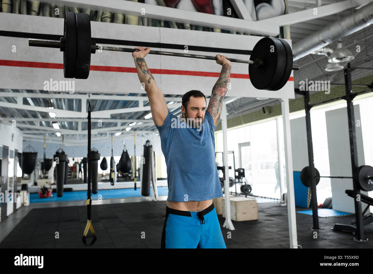 Mid adult man weight lifting in gym Stock Photo