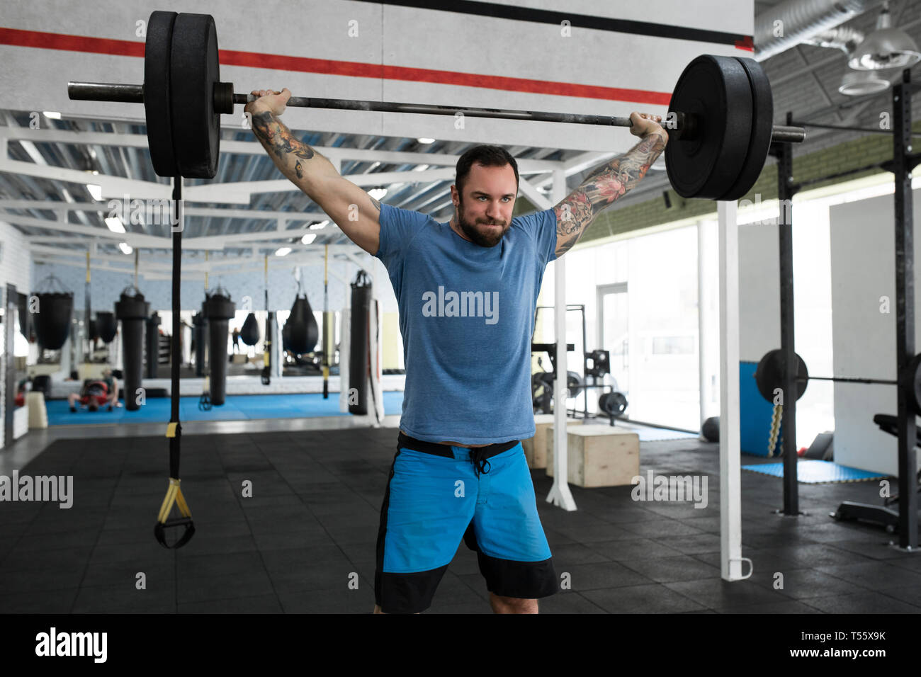 Mid adult man weight lifting in gym Stock Photo