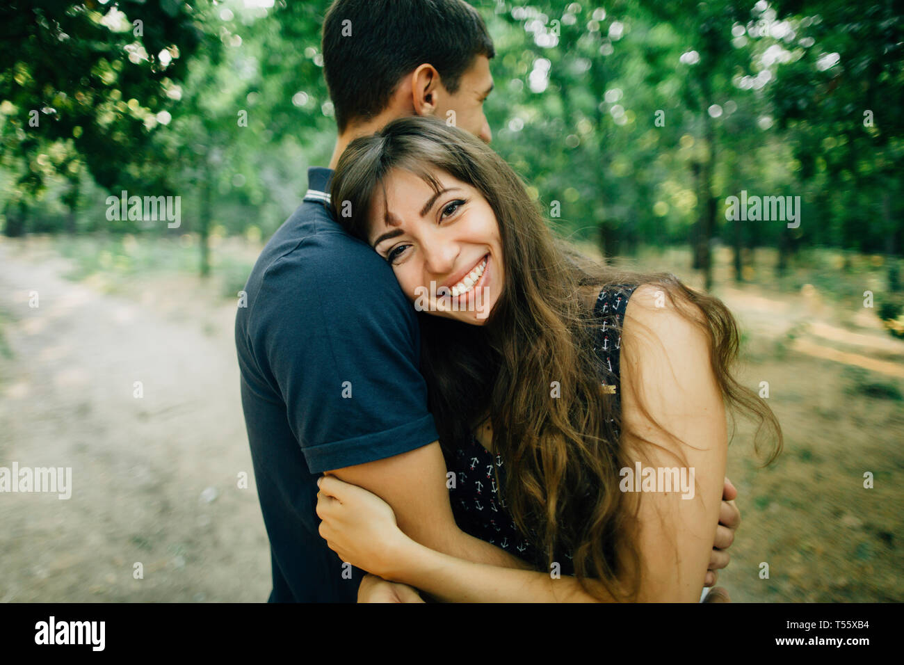 Young couple embracing in park Stock Photo