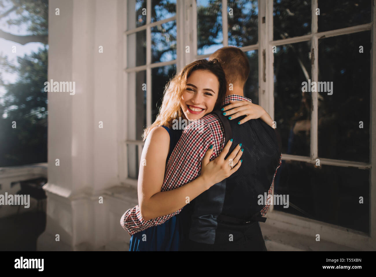 Young couple hugging by window Stock Photo