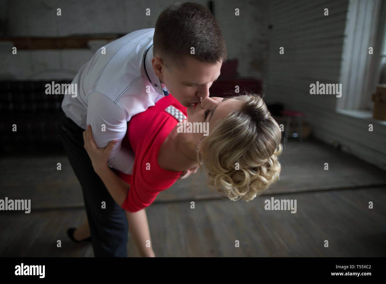 Man dipping and kissing woman Stock Photo