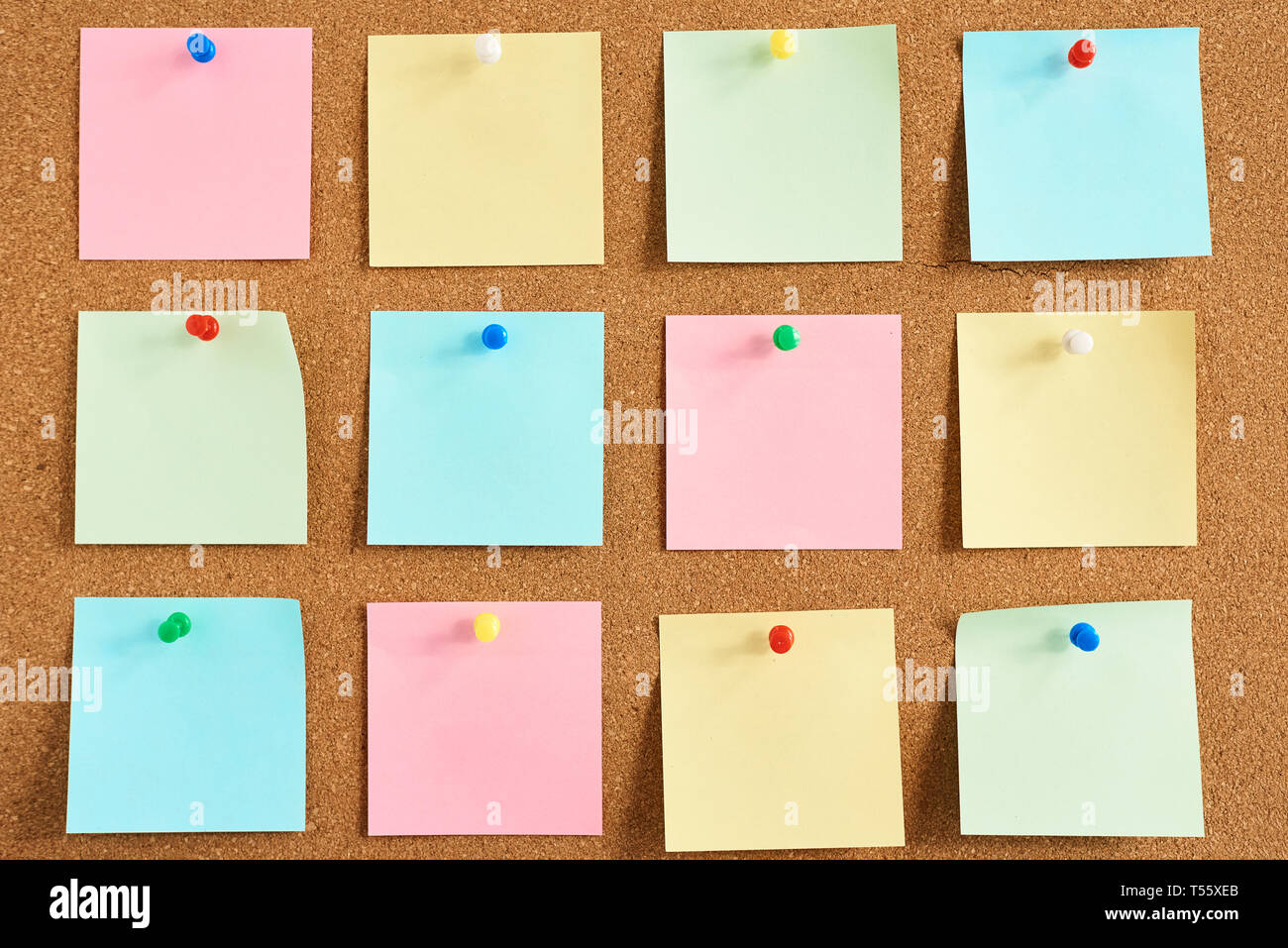 Cork board with pinned colored blank notes Stock Photo