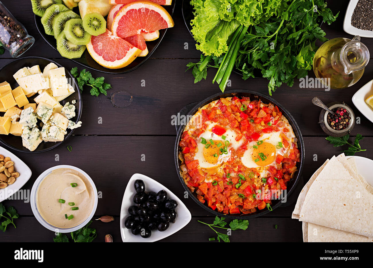 Turkish Breakfast -  shakshuka, olives, cheese and fruit. Rich brunch. Top view Stock Photo