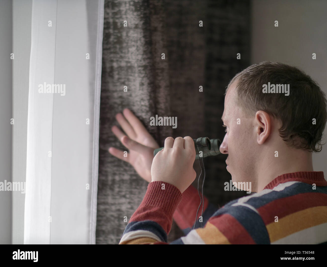 Spying out of window hi-res stock photography and images - Alamy