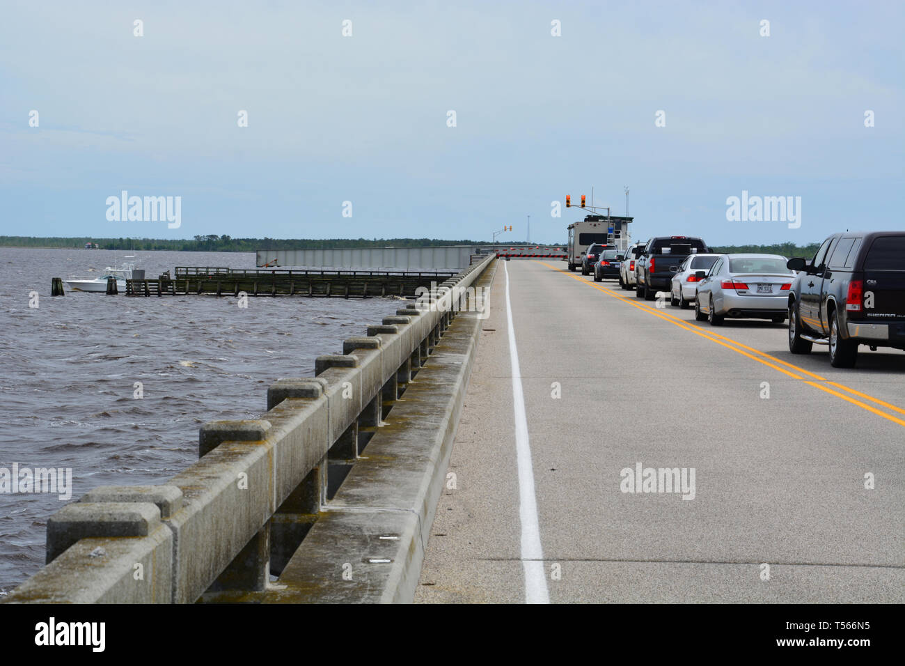 Traffic headed for the Outer Banks stop to lets boats pass where the Inter-Coastal Waterway crosses US-64 on the Alligator River bridge. Stock Photo